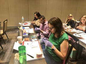Several people doing orthodontics training