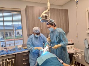 Dr. Mughal and staff member Alicia working with a patient